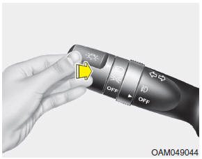 To turn on the high beam headlights, push the lever away from you. Pull it back