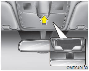 To open the sunglass holder, press the cover and the holder will slowly open.