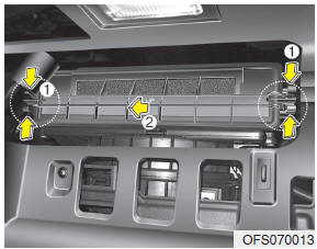 3. Remove the climate control air filter cover while pressing the lock on the
