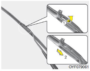 2. Lift up the wiper blade clip. Then pull down the blade assembly and remove